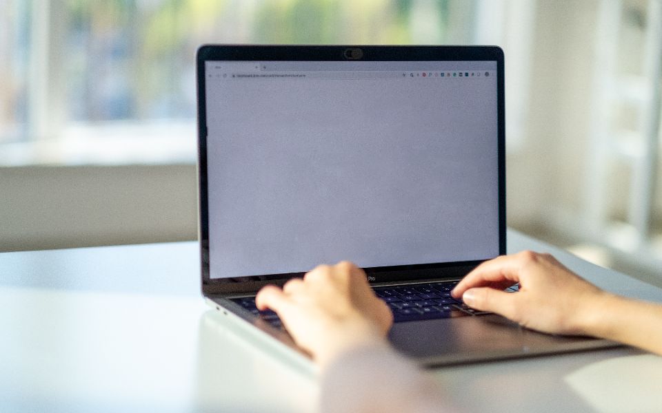 A laptop on a desk, set up for a one-to-one online lesson